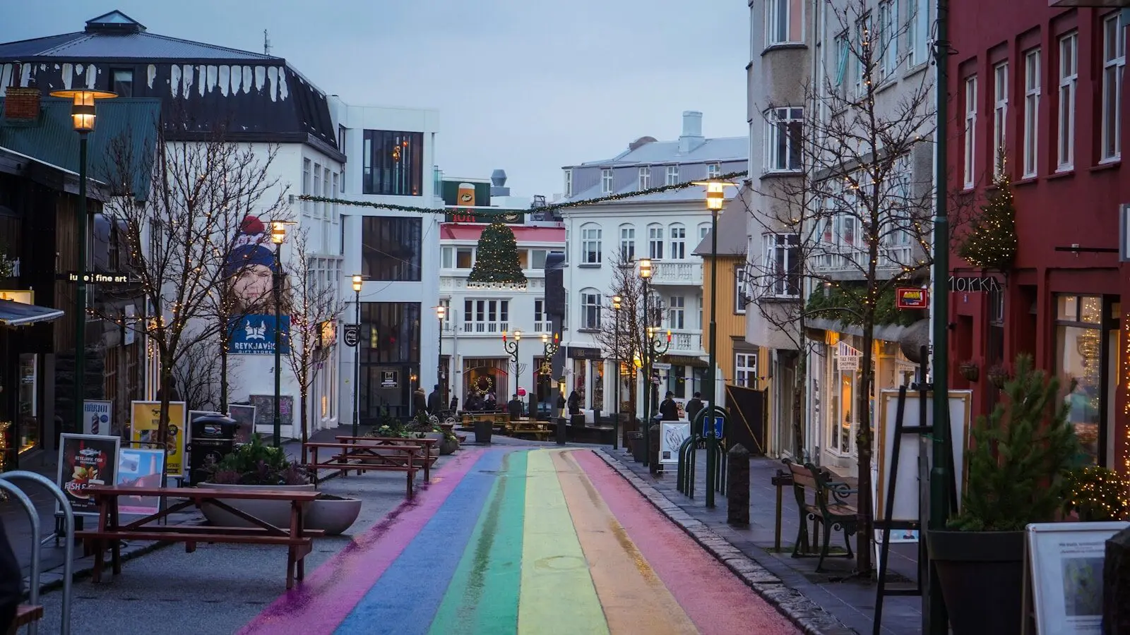 a rainbow painted street in the middle of a city